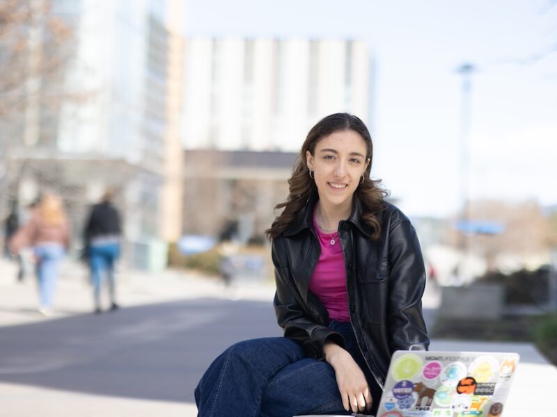 Abby with her laptop on the UBC Okanagan campus