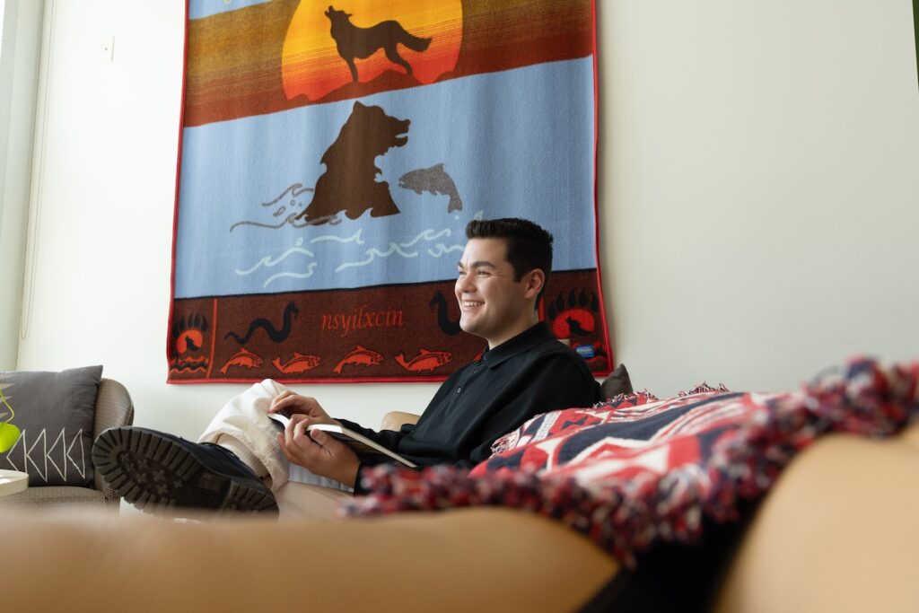 Noah reading a book in the Indigenous Centre