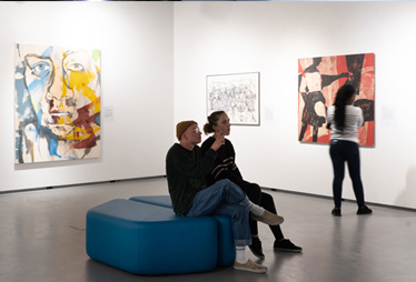 Visitors admiring art and the UBC Okanagan Gallery