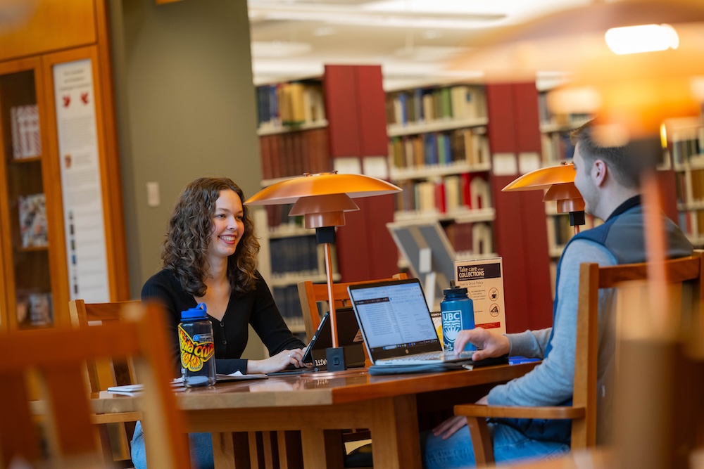 Elleda with another student studying at the library.