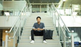 Rahman sitting on stairs at UBC Okanagan