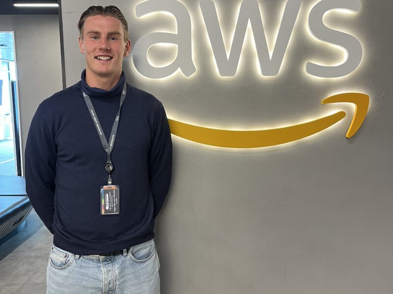 Axel standing in front of the Amazon sign at his work