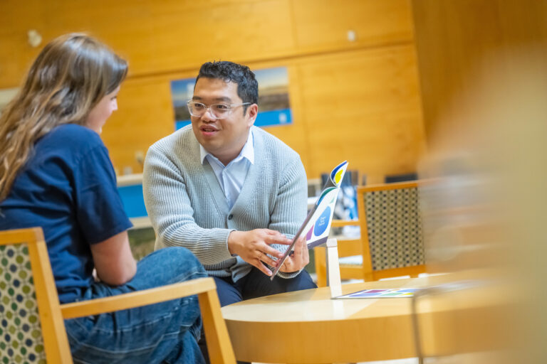 Student sitting with recruiter at a table